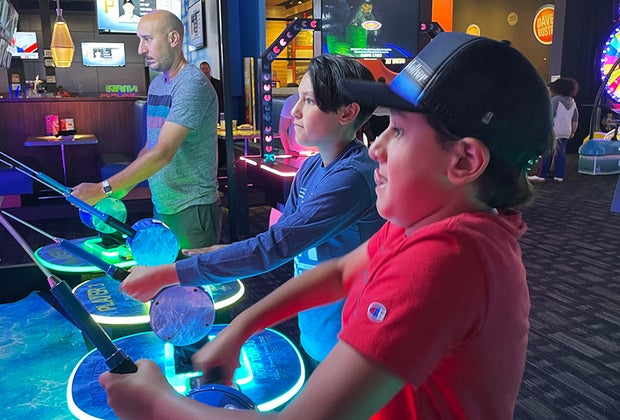 playing arcade games at Dave & Busters Long Island Arcades