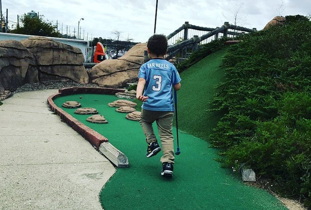 Mini-Golf Courses on Long Island child playing mini golf at County Fair Park