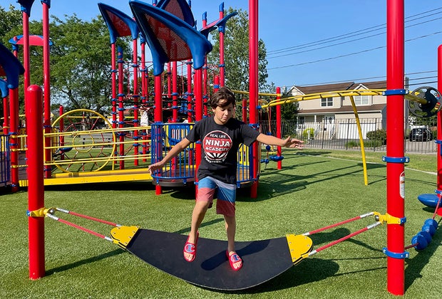 Newbridge Road Park Playground boy on a land surfboard balancing