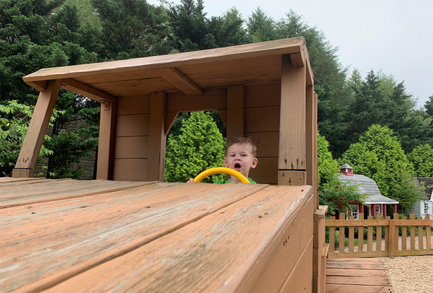boy driving a big wooden truck on a playground