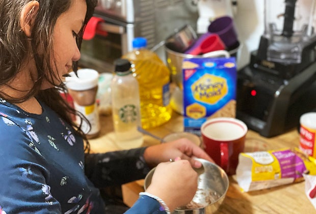 Girl mixes together a mug cake