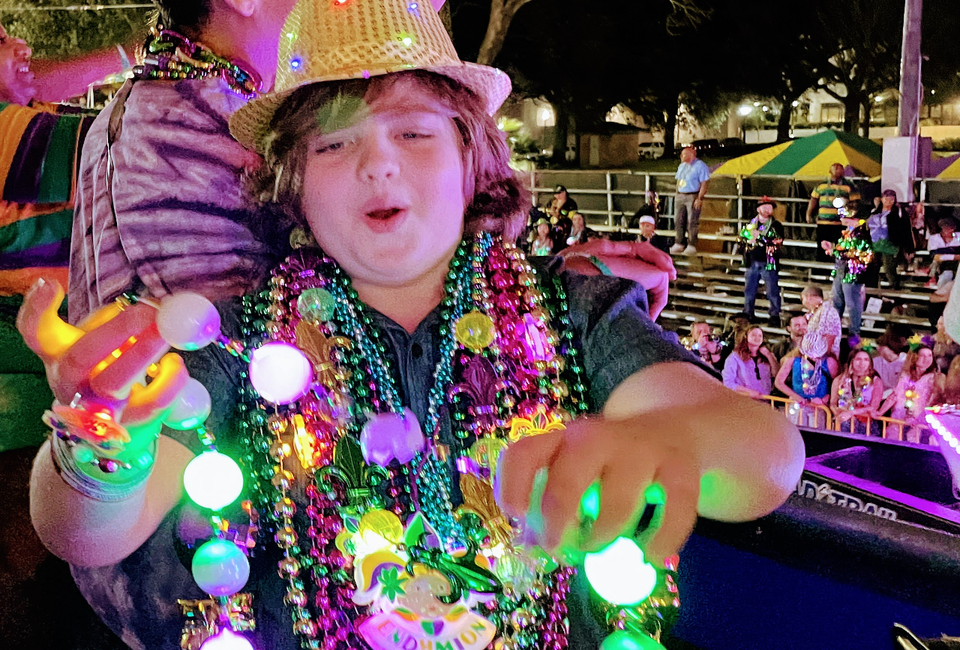 <i>Kids absolutely love catching Mardi Gras beads.</i>