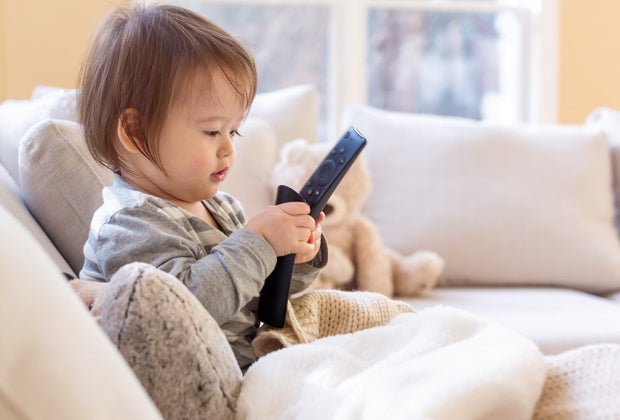 Child palying with a tv remote control.