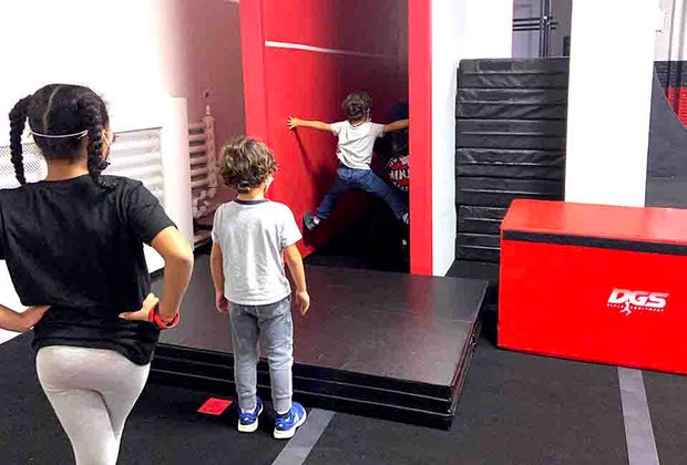 boy climbs through spider wall