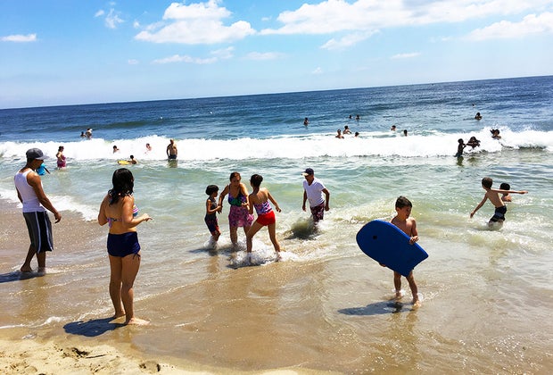 People on the beach in the sand and waves