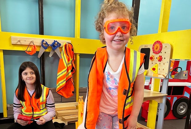 Trendy New Jersey Experiences for Kids: Adventure Nook girl in playing pretend construction gear
