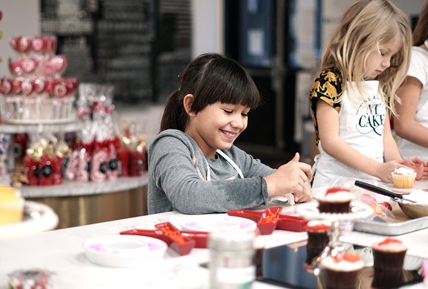 girl decorating desserts at a cooking class
