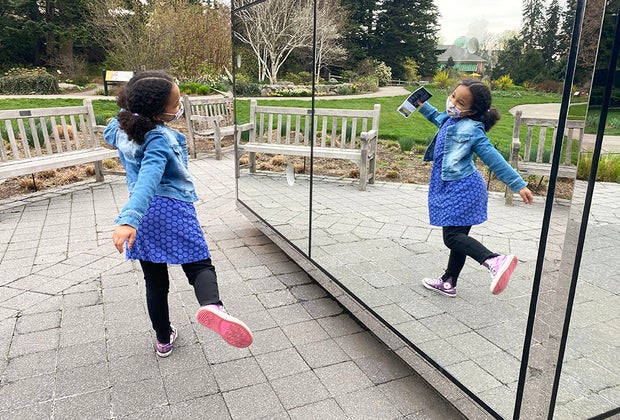girl dancing in the mirror of Kusama's Infinity Mirrored Room at NYBG