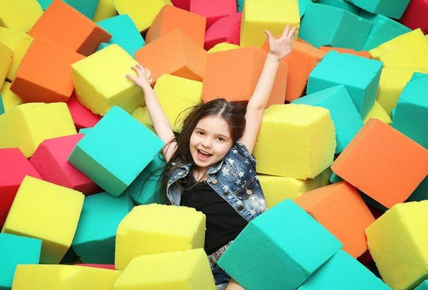 Girl in a foam pit at Kids 'N Shape, a trampoline park in New York City