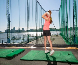 Swing into action with a golf summer camp at Chelsea Piers. Photo courtesy of Chelsea Piers