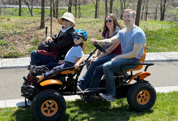Things to do on Governors Island with kids: Family enjoying a surrey rental