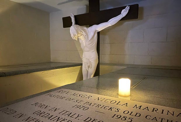 Things To Do in Little Italy with Kids: a Crucifix and candle at St. Patrick's Catacombs