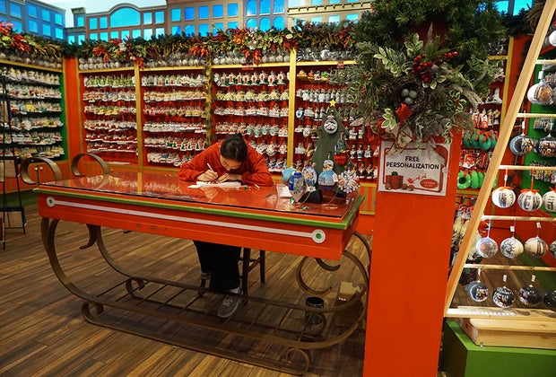 Things To Do in Little Italy with Kids: Christmas in New York Girl writing Christmas list to Santa
