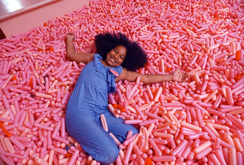 Diving into the sprinkle pool at the Museum of Ice Cream is a great way to cure rainy day blues. Photo by  Jody Mercier