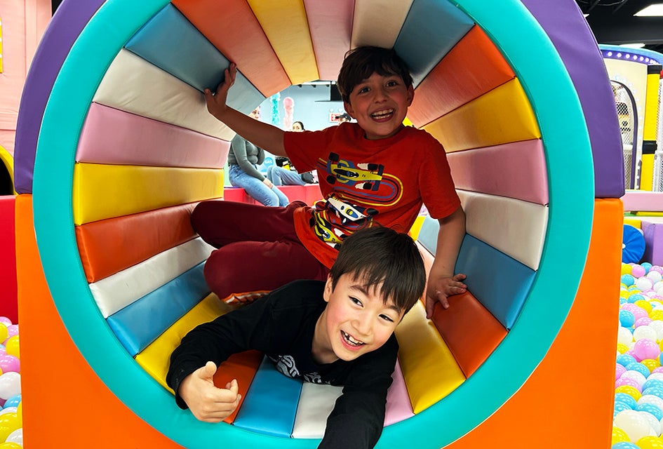 Climb, crawl, jump, and slide on the mutli-level play structures at Rainbow Playspace. 