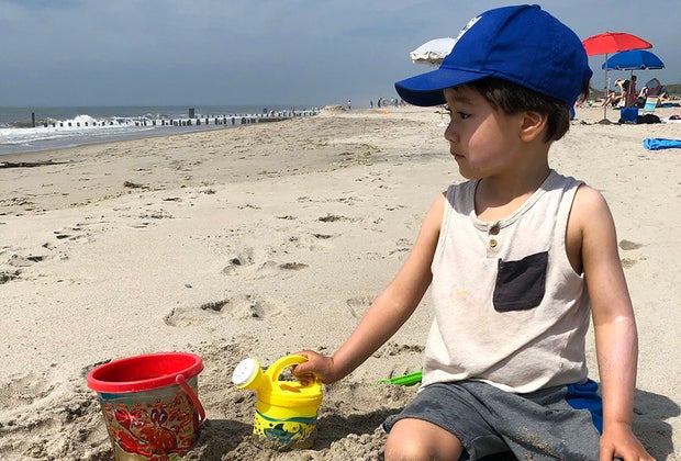 Rockaway Beach with Kids: Small child with bucket on the beach
