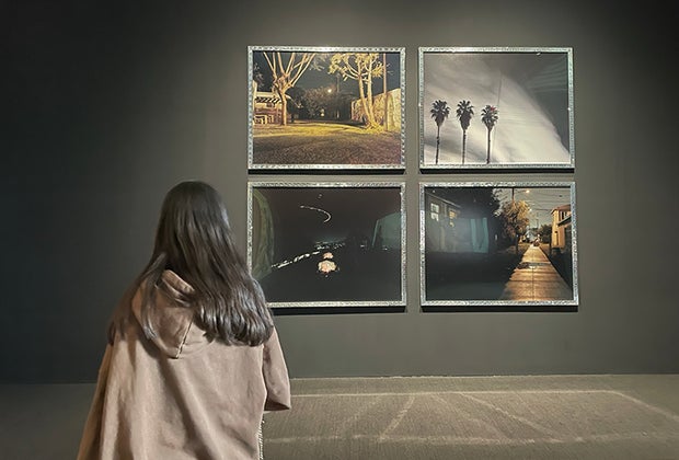 Visiting the Whitney Museum in NYC with Kids: Girl staring at a collection of paintings