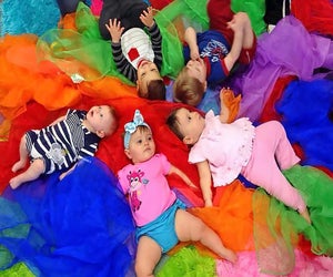 Babies experience colorful, sensory play at A Kids Gym.