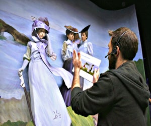 A pageant sculptor helps volunteer cast members into their poses at a rehearsal. Photo courtesy of Laguna Beach Festival of Arts