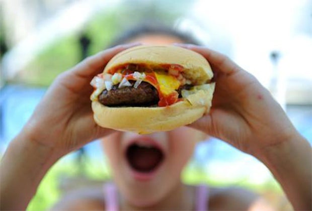girl eating a hamburger at squareburger