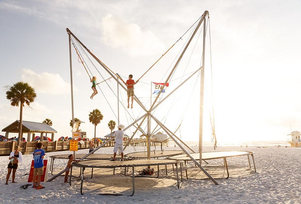 kids doing a bungee trampoline jump on the beach ni clearwater