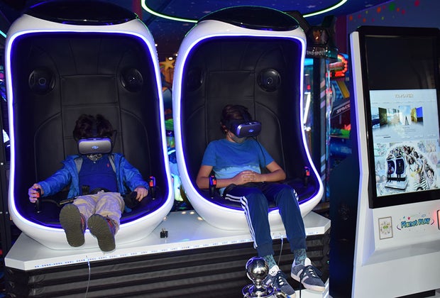Two kids in virtual reality pods