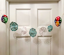 Making paper snowflakes from recycled wrapping paper is easy and fun for kids. Photo by the author