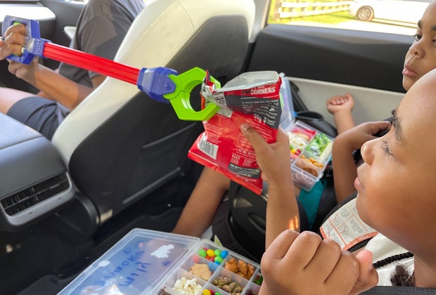 kids using a grabber in the car