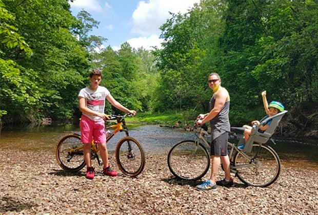 Family poses for a picture along a bike path