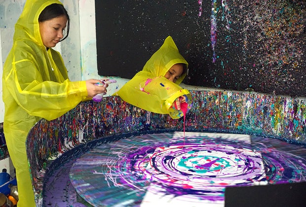 Shot of Art NYC: Two girls dripping paint on a splatter wheel