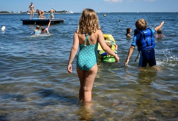 Image of children swimming at a beach and swim club in Connecticut.