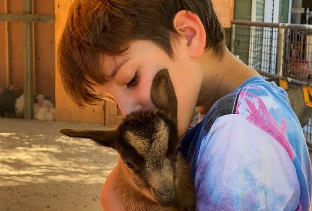 A goat hug makes any day brighter. Photo courtesy of Kfar Saba Urban Farm 