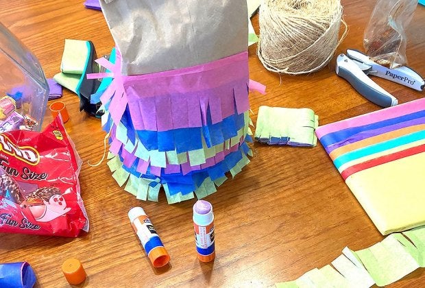 It's easier than you'd think to turn a simple paper lunch bag into a festive piñata!
