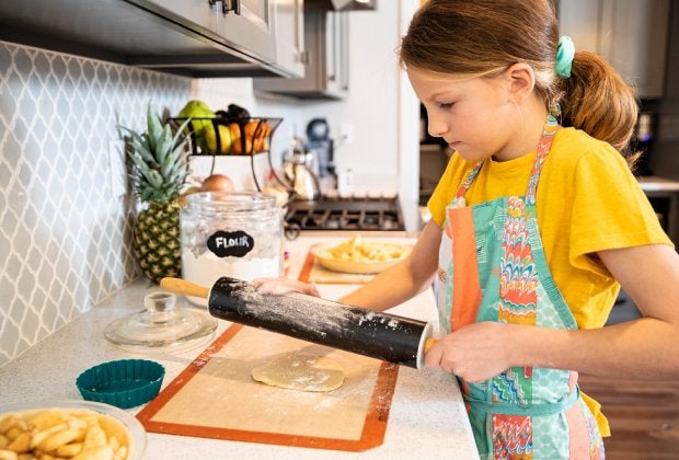 girl making apple pie courtesy of canva