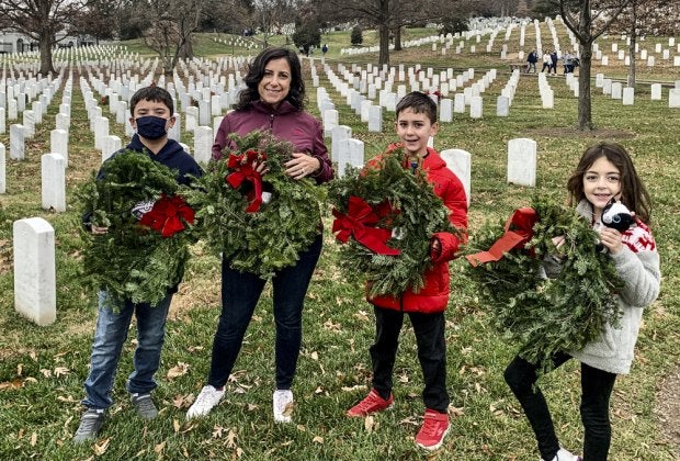 Place wreaths at the graves of fallen soldiers during the annual Wreaths Across America event. Photo courtesy of the author
