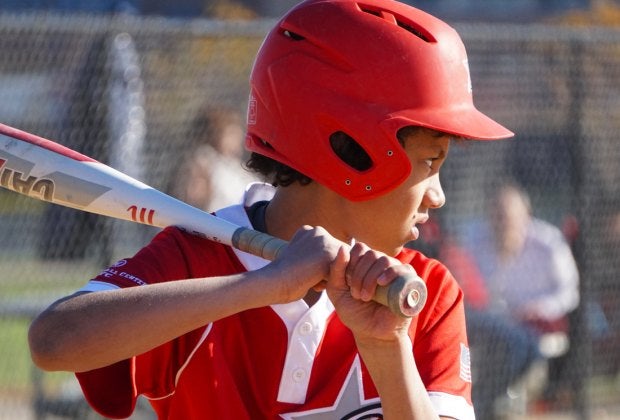 Little boy at bat. Photo by Jodi Mercier for Mommy Poppins