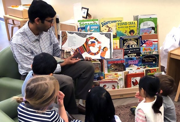 Children gather around for story time at Bright Horizons. 