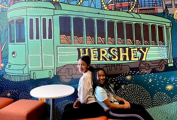 Pose for a post-card worthy photo in front of the Hershey-themed mural at Tru by Hilton Hershey Chocolate Avenue during your stay.