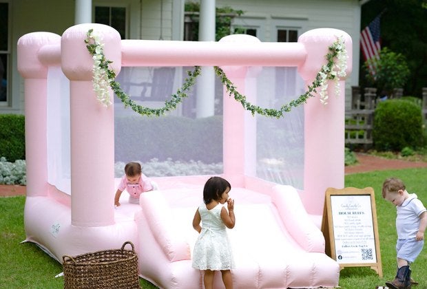 Add a charming bounce house, like this one from Candy Castle Co., to enhance your child's next birthday party. Photo by Wilson Creative Co. Photography, courtesy of Candy Castle Co.