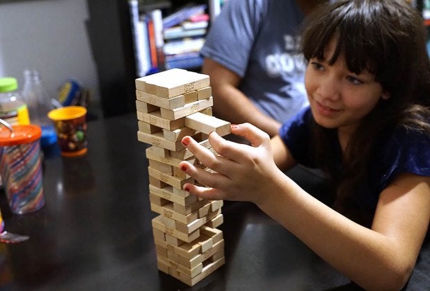 Pull out a block, place it on top but don't let the tower fall in the fun and challenging Jenga.  Photo by Jody Mercier