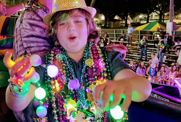 <i>Kids absolutely love catching Mardi Gras beads.</i>