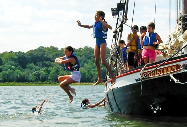 Take the wheel aboard the former oyster sloop Christeen in Oyster Bay.  Photo courtesy of  The WaterFront Center