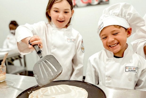 At Young Chefs Academy, kids are guided through a stage-by-stage cooking class that allows them to build on their newfound skills. Photo courtesy of Young Chefs Academy