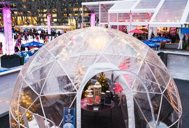 Revel with the family in your own private igloo at Bryant Park's Winter Village. Photo by Kevin Ornelas