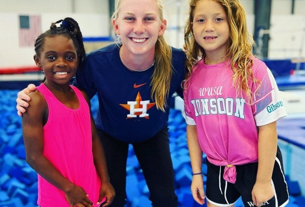 Two girls enjoying a fun gymnastics summer camp in Houston. Photo courtesy of the Houston Gymnastics Academy