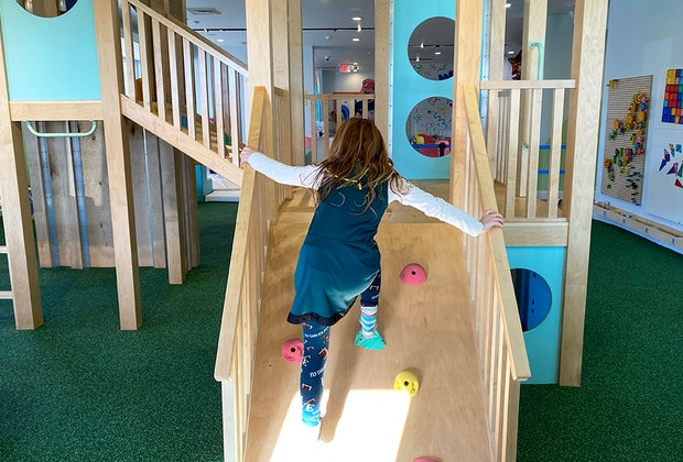 Trendy New Jersey Experiences For Kids: Wild Child Play climbing up an indoor slide
