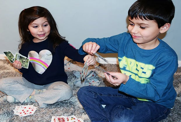 Kids play card games together.