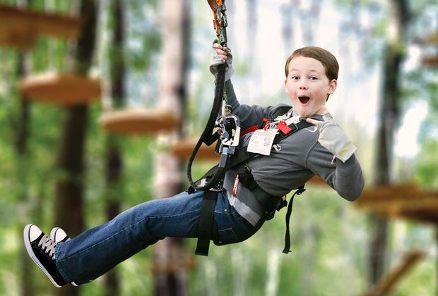 Photo of a child on a zip line, a popular Father's day activity.
