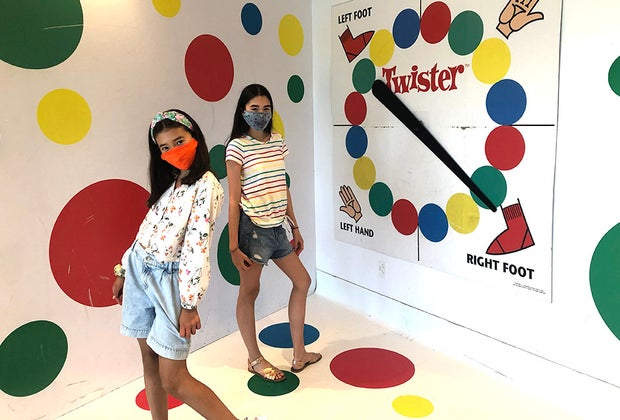 girls posing on giant twister board
