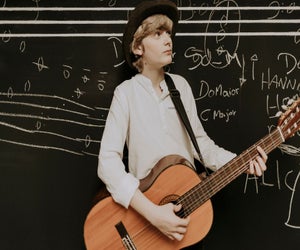 Boy playing guitar. Photo courtesy Canva